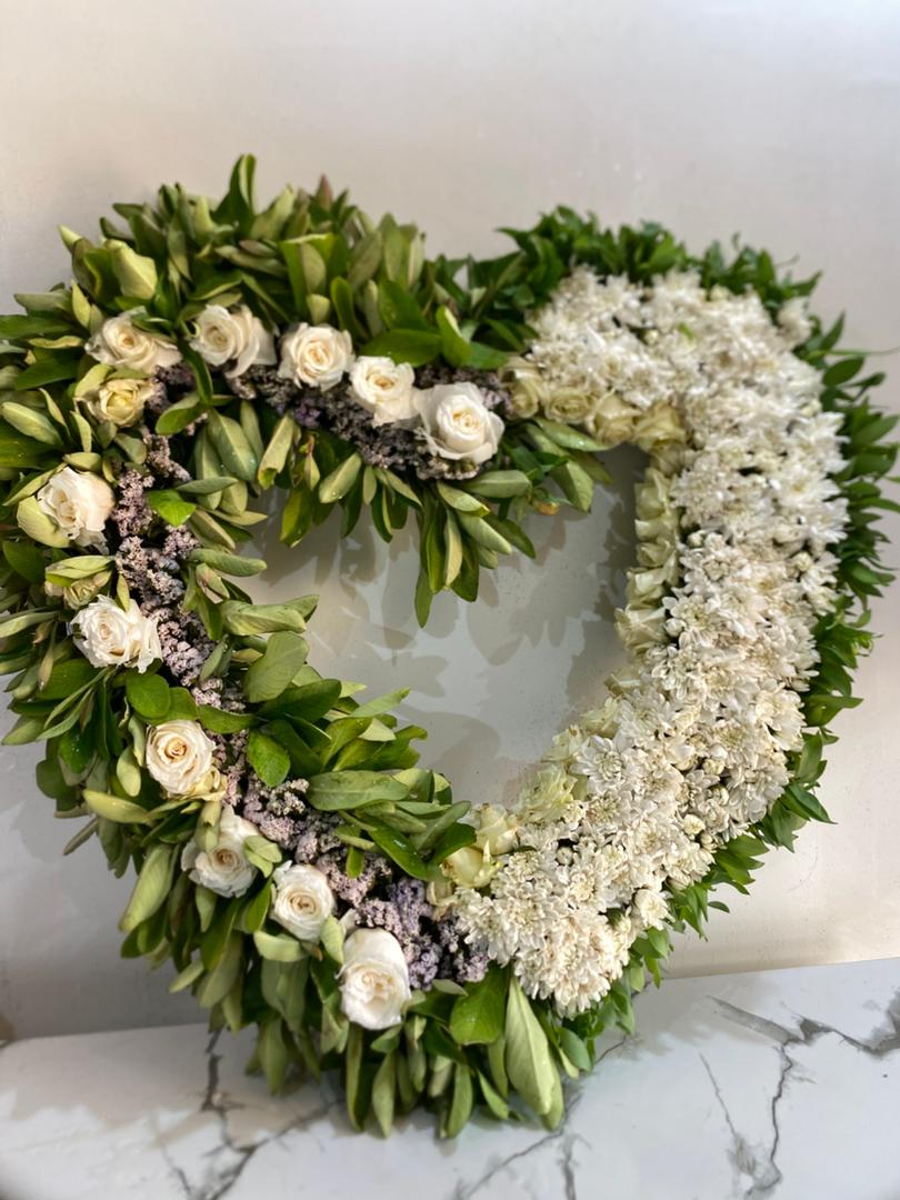 White heart-shaped tribute wreath